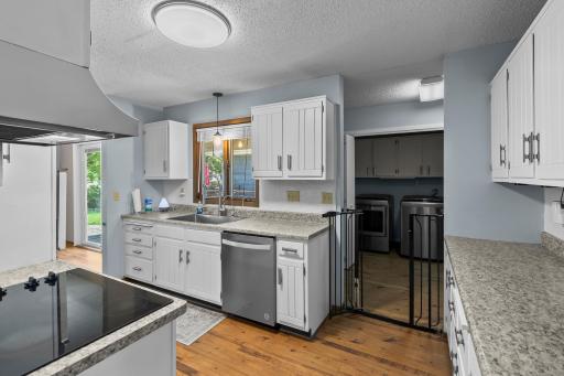 Spacious kitchen with crisp white cabinetry, stainless steel appliances, and loads of counter space.