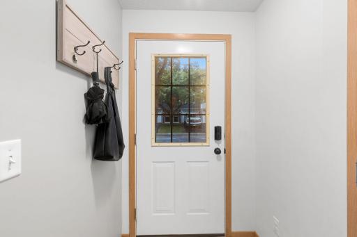The entry has a privacy window and a new lock system. Access to your garage is to the right (door to garage is not shown on the photo).