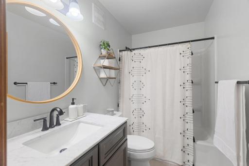 The bathroom on the upper level is ALL NEW and SO beautiful!!! Everything has been done - NEW: Vanity, Tub/Shower, Hardware, Mirror, Lighting, Flooring, Toilet! Freshly painted!!!