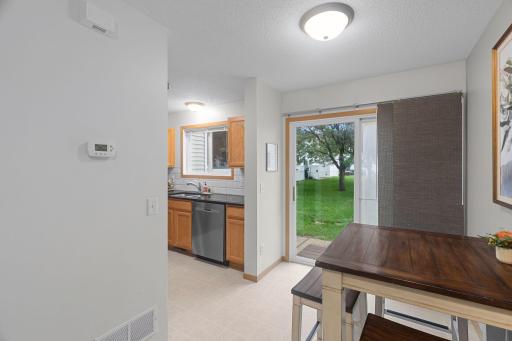 Dining space is conveniently located adjacent to the kitchen. Head out the slider door to your patio for grilling season!