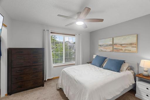 Upstairs the primary bedroom has a NEW ceiling fan, window treatments and freshly painted.