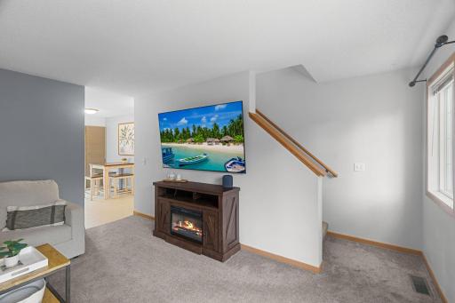 Living room with views toward the dining space and access to the upper level.