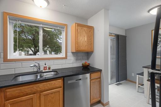 Beautiful subway tile and granite countertops in this wonderful kitchen -- and YES, a kitchen window!!!
