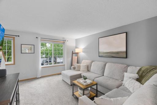 Wonderful windows let in natural light -- this cozy living room is the perfect place to chill after a long day.