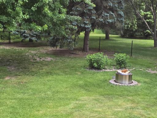 Fire pit area with granite surround and fenced yard