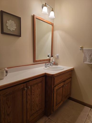 There is a main floor half bath near the front door foyer and hallway that is leading to the kitchen with impressive tile floor coverings.