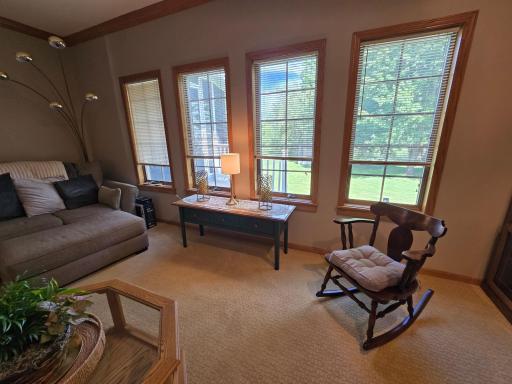 Home features a carpeted sunken fireplace family and friend room with lots of large window lighting.