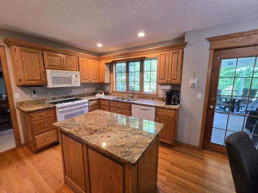 Note the granite counter tops and hardwood floors leading to the formal carpeted dining room. Coffee anyone!
