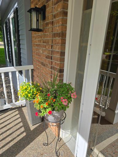 Brick surrounds the front entry with washed stone and sidewalk entry