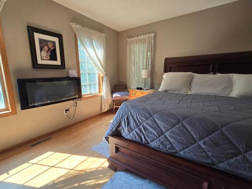 Main owners suite bedroom has a wall fireplace for beauty and comfort
