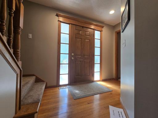 Foyer has hardwood floors and carpet to upper level