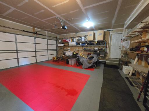 Garage is a triple and has a unique color floor tile and ample wall storage