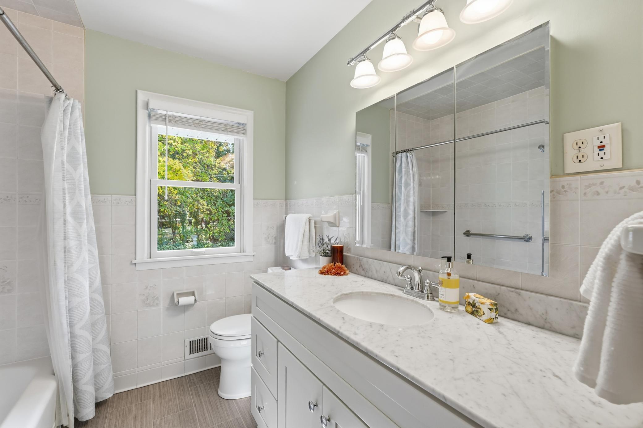 Main level full bath with views of the private yard.