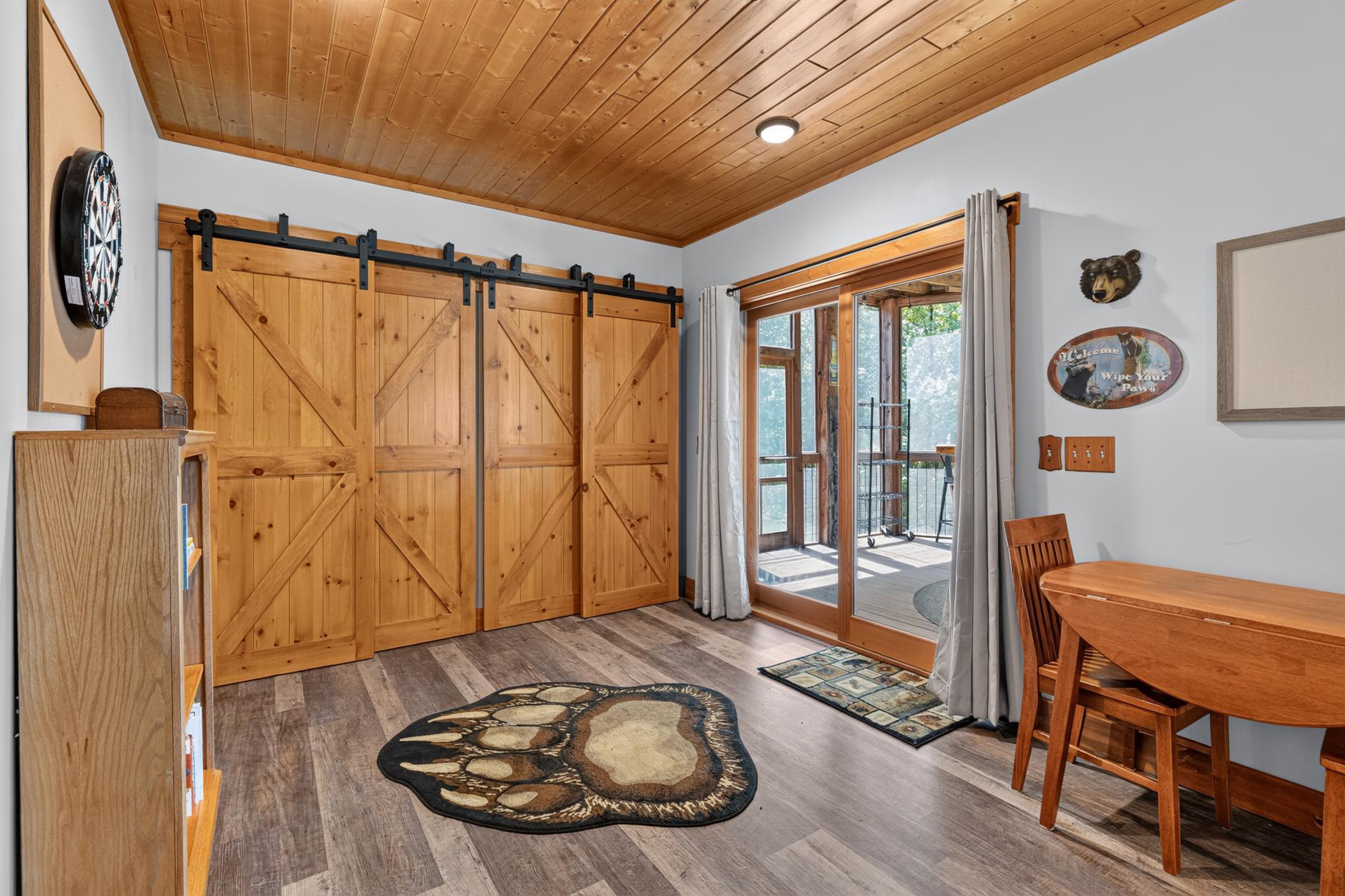 Large closet for the outdoor toys, and sliding door leading to the screened patio.
