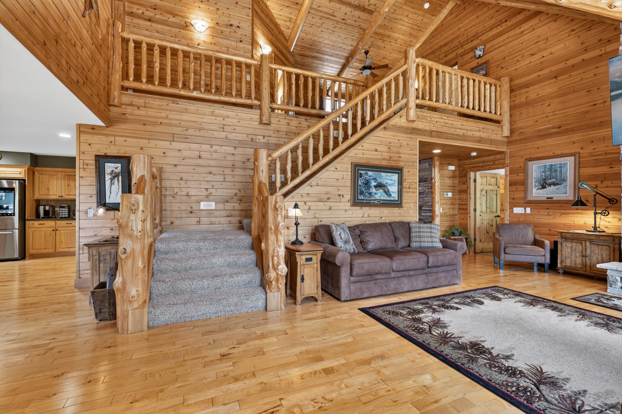 Wide log staircase to upper level.