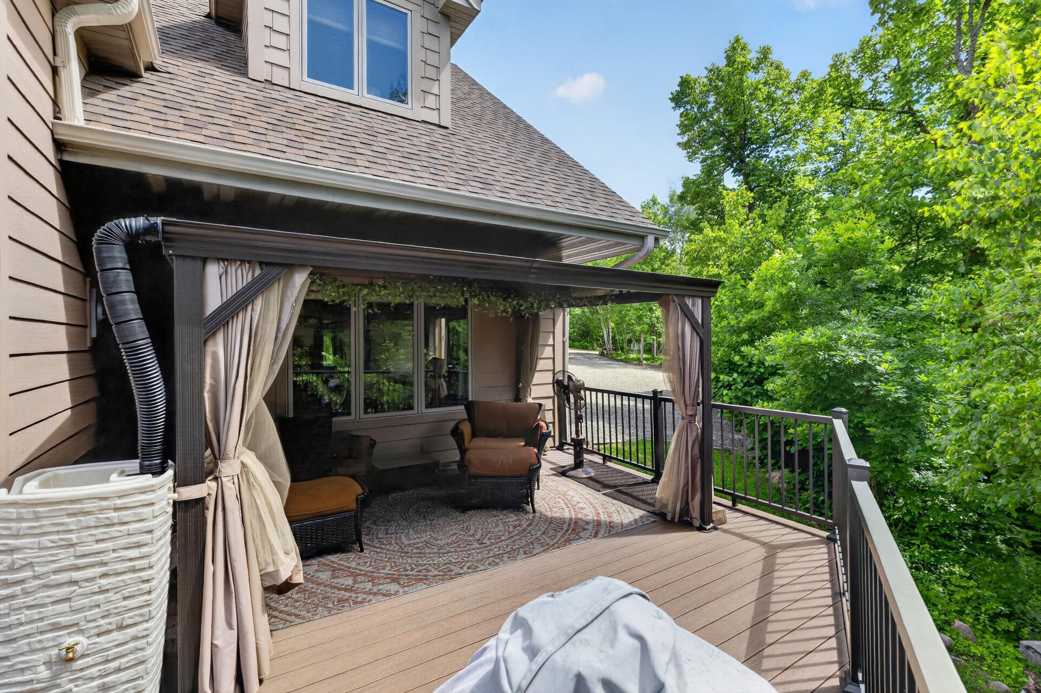 Screen gazebo with metal roof and gutter is a beautiful addition to the deck.