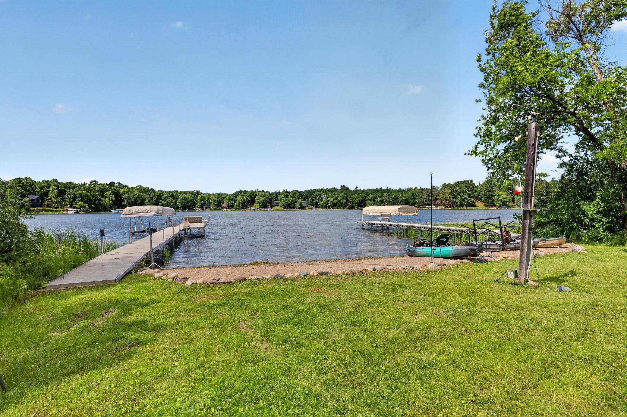 Two docks and lifts with sandy swimming beach in between.