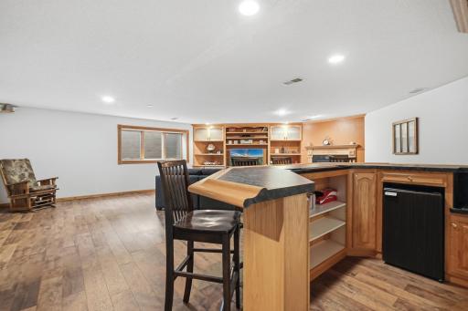 The wet bar has a functioning sink and refrigerator.