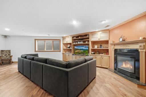Gas fireplace and ample built ins highlight the family room.
