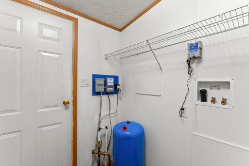 The laundry room is conveniently located right by the back door for those dirty laundry days.