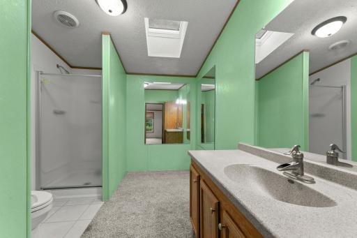 The primary bathroom features a shower plus extra space to add in a tub or for extra storage.