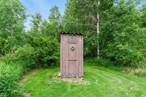 Your new home includes the cutest outhouse!