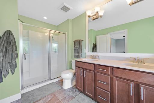 The primary bathroom, is... wow! Dual sinks, separate tub and shower, and lots of light from the big window.