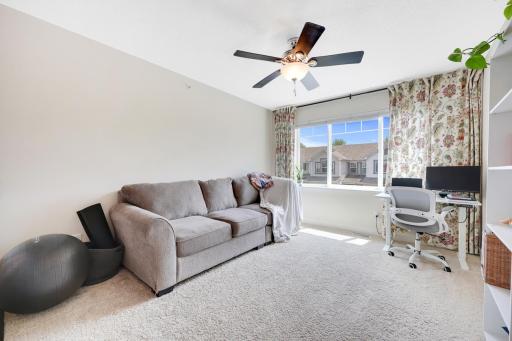 The upper level has a fantastic loft with a big window. Great for a den, office, or play area!