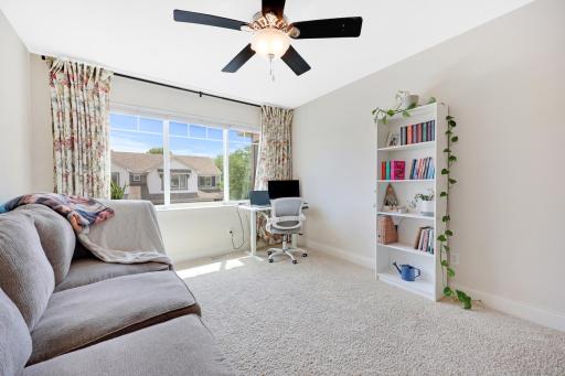 The upper level has a fantastic loft with a big window. Great for a den, office, or play area!