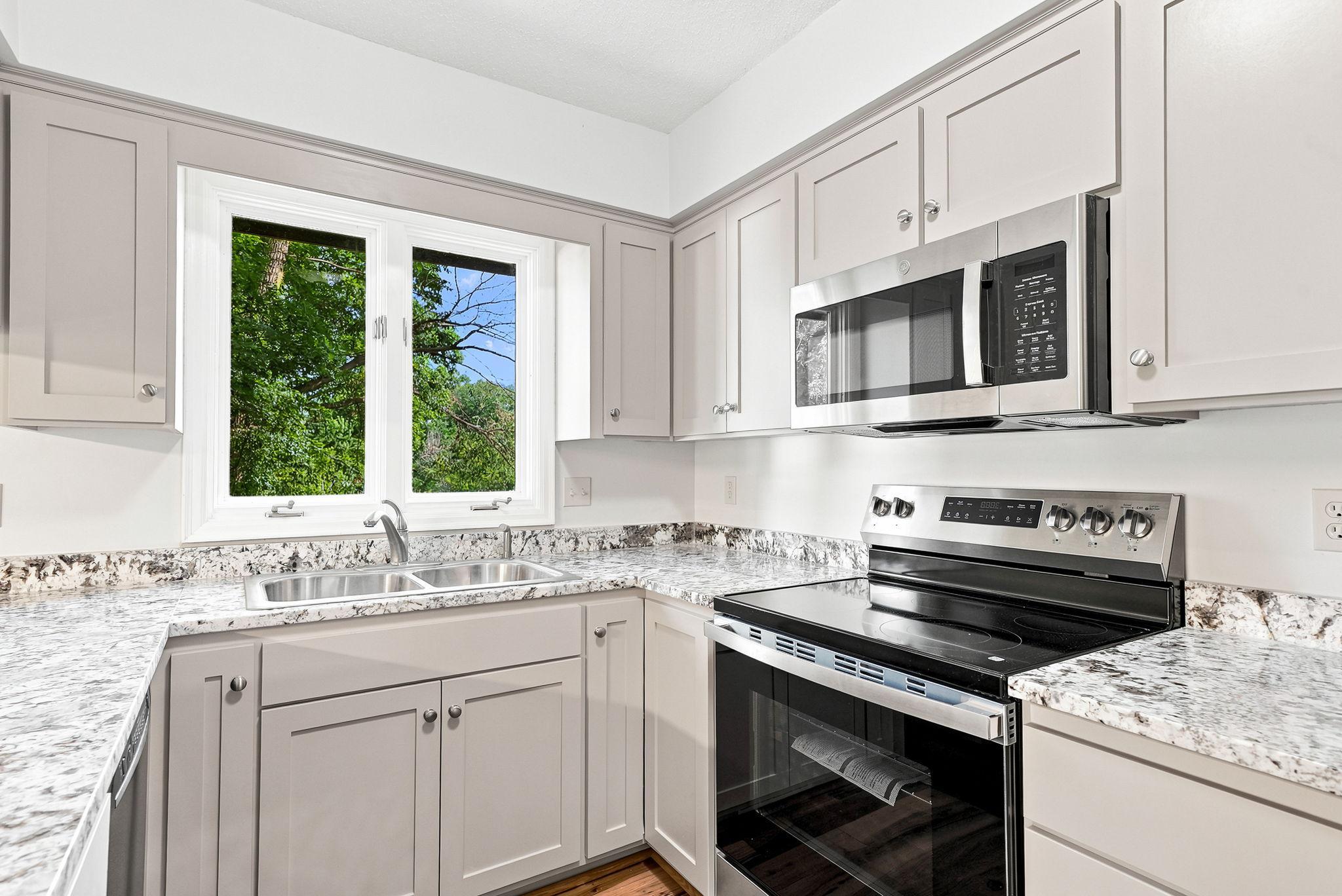 Notice the stainless appliances and kitchen window
