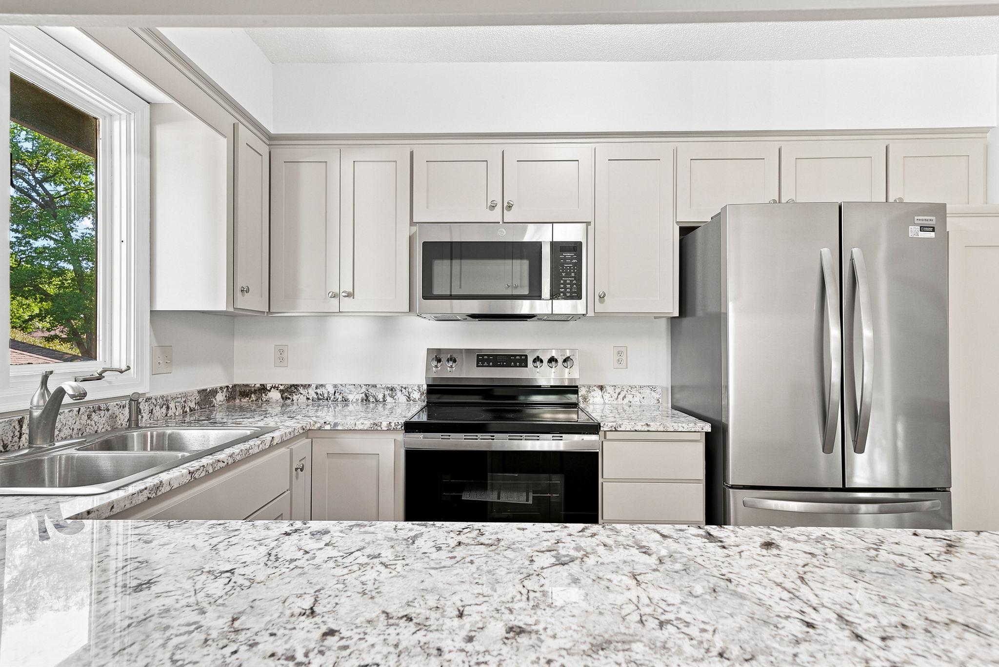 The kitchen was recently updated with granite countertops, stainless appliances, new flooring and granite countertops.