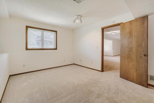 The spacious fourth bedroom in the lower level is the perfect retreat for guests, teenagers, or extended family. Featuring brand-new plush carpeting and a large daylight window that fills the room with natural light,