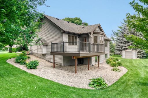A storage shed provides valuable additional space for lawn equipment, gardening tools, bicycles, and seasonal items, helping keep the oversized three-car garage organized and clutter-free. This backyard offers the perfect blend of privacy & beauty,
