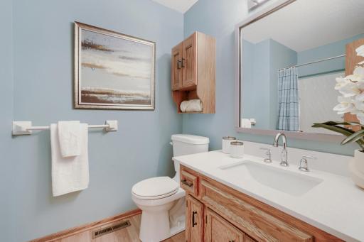 The main-level full bathroom is bright, fresh, and thoughtfully updated. The full tub and shower combination is perfect for busy mornings, relaxing evening baths, or accommodating young children and overnight guests