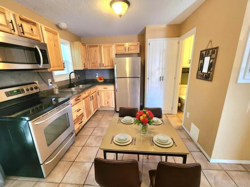 The updated kitchen offers Knotty Hickory cabinetry, stainless appliances and updated fixtures.(virtually staged)
