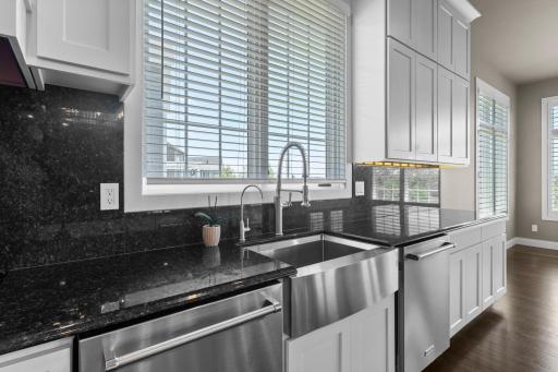 This gourmet kitchen also features a stainless farmhouse sink, reverse osmosis system for drinking water and dual dishwashers, designed for both everyday living and effortless entertaining.
