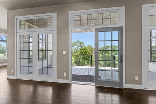 Windows and doors create the illusion of a wall of glass, opening to a maintenance-free deck and delivering continuous indoor-outdoor living.