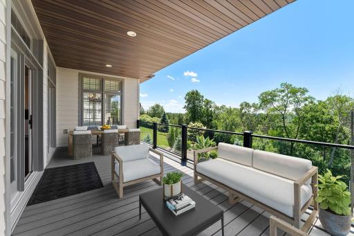 A covered deck with picturesque views provides a serene outdoor retreat, perfect for relaxing, entertaining, and enjoying the surrounding scenery in every season.
