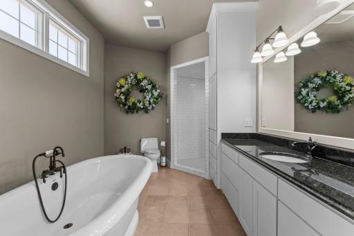 Primary spa-inspired bath with freestanding tub, toilet, and bidet.