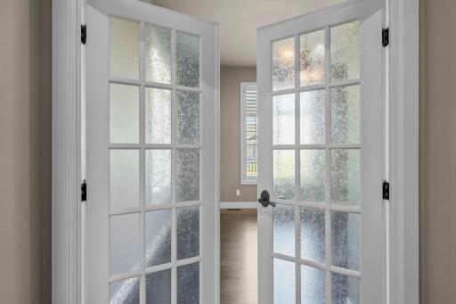 Office with French doors, offering a quiet, light-filled space that can also function as a media room or additional bedroom.