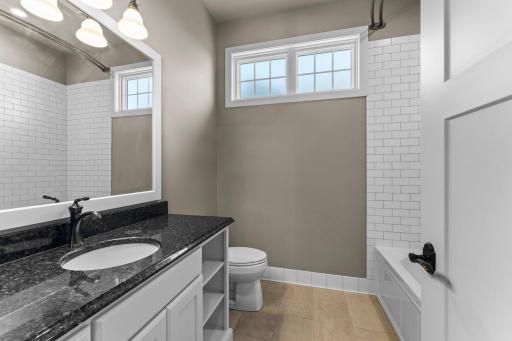 Main level full bathroom with Granite countertop.
