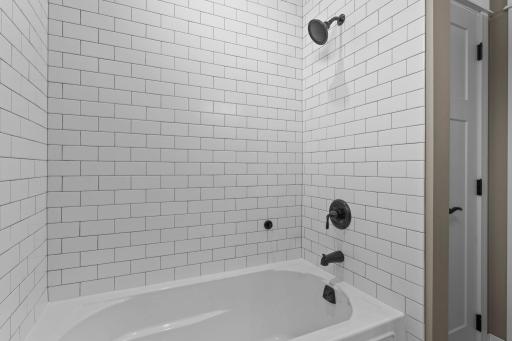 Main level bathroom tiled shower and deep soaking tub.