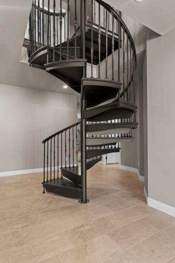 Unique spiral staircase descending to the lower level, adding architectural interest and a distinctive design feature that connects both levels with style and character.
