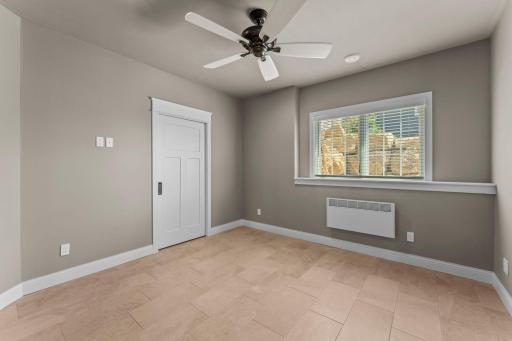 Lower-level bedroom 1 with additional heating system. Walk in closet with pocket door and motion activated lighting in the closet.
