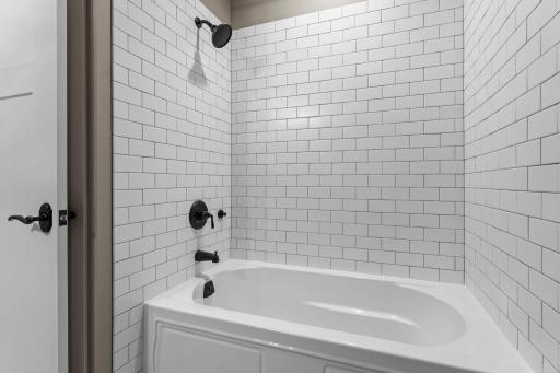 Soaking tub with full ceramic tile. All door handles throughout the home are solid bronze.