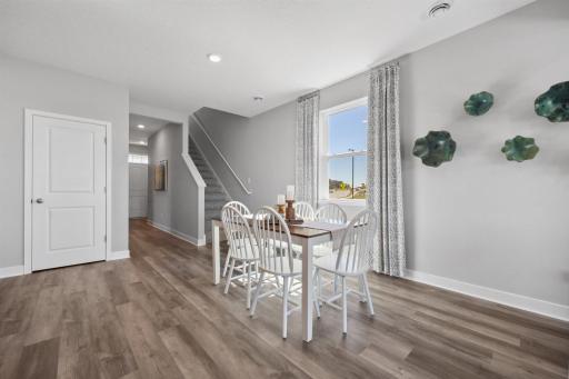 The dining space is adjacent to the kitchen and living room providing a great layout for entertaining and everyday living. Photo of model home, colors and finishes will vary.