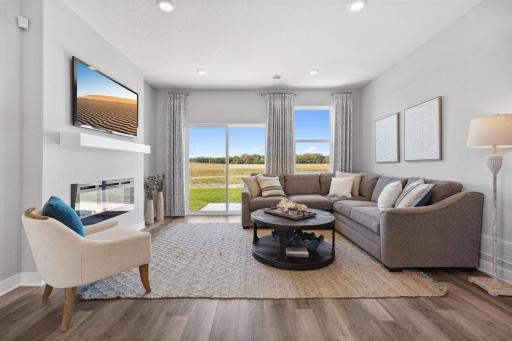 Large windows again add to the open and airy feel that is carried into the living room off the Kitchen. Photo of model home, colors and finishes will vary.