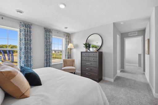 Another view of the primary bedroom. Photo of model home, colors and finishes will vary.