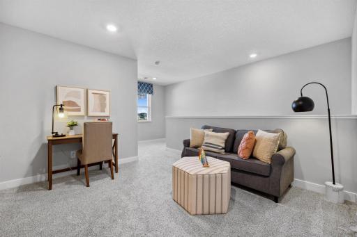 The upper level loft would be a perfect playroom, game room, watch TV or reading room, the options are endless. Photo of model home, colors and finishes will vary.