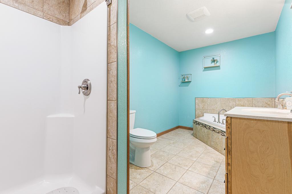 The main floor full bath features tile floors, a large corner jetted tub, and walk-in shower! Talk about a beautiful guest bath!